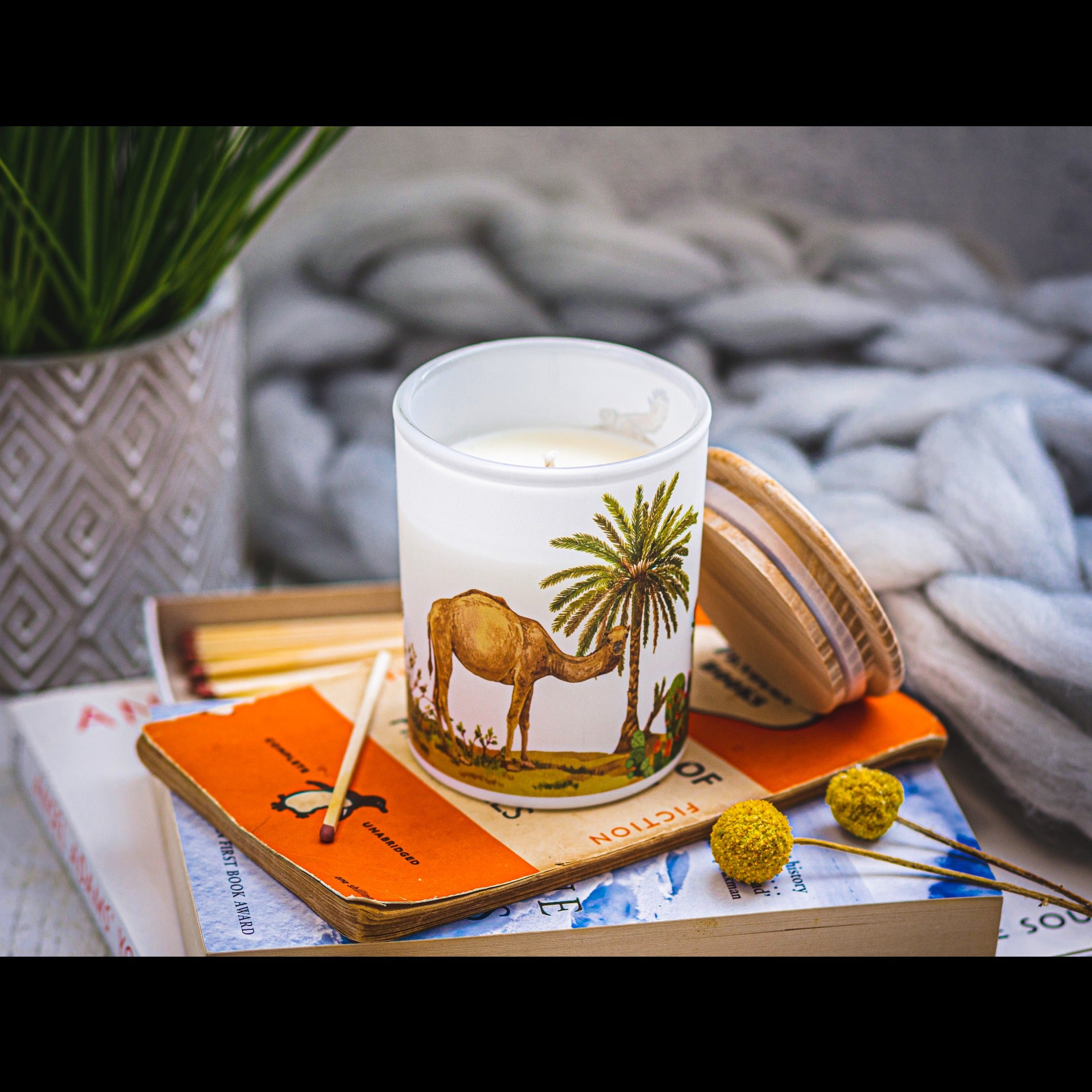 Luxury eco soy candle with camel and palm tree desert design, hand-poured natural wax in reusable glass – Sundara Casa.